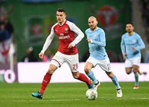 Images Dated 25th February 2018: Xhaka vs Silva: Clash of Midfield Titans - Arsenal v Manchester City Carabao Cup Final