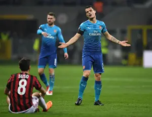 AC Milan V Arsenal 2017-18 Prints: Xhaka vs. Suso: Intense Rivalry in Arsenal's Europa League Clash with AC Milan