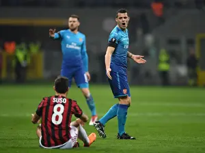 AC Milan V Arsenal 2017-18 Prints: Xhaka vs. Suso: Intense Rivalry in the UEFA Europa League Clash Between AC Milan and Arsenal